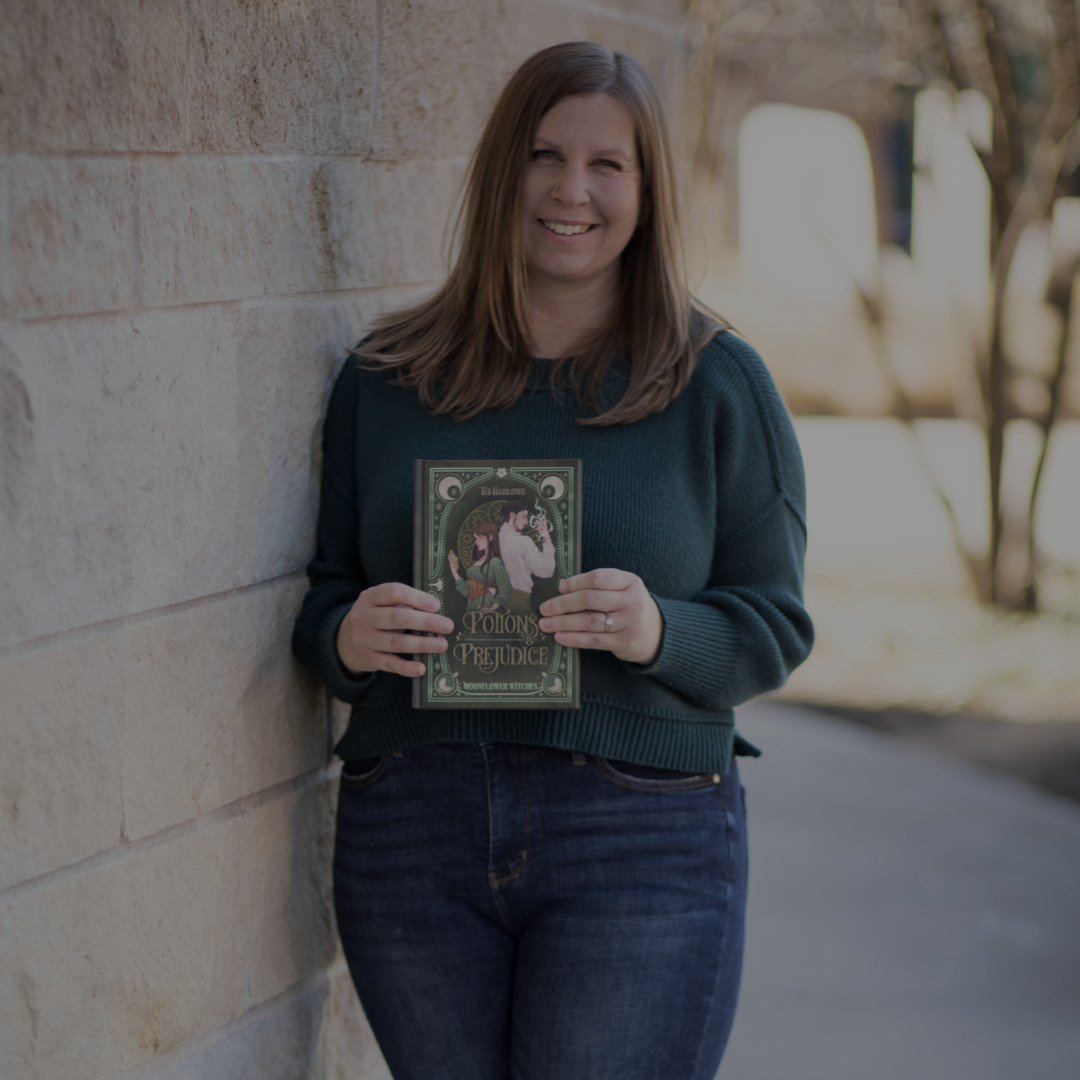 Bestselling Author Tee Harlowe holding a book against a stone wall.
