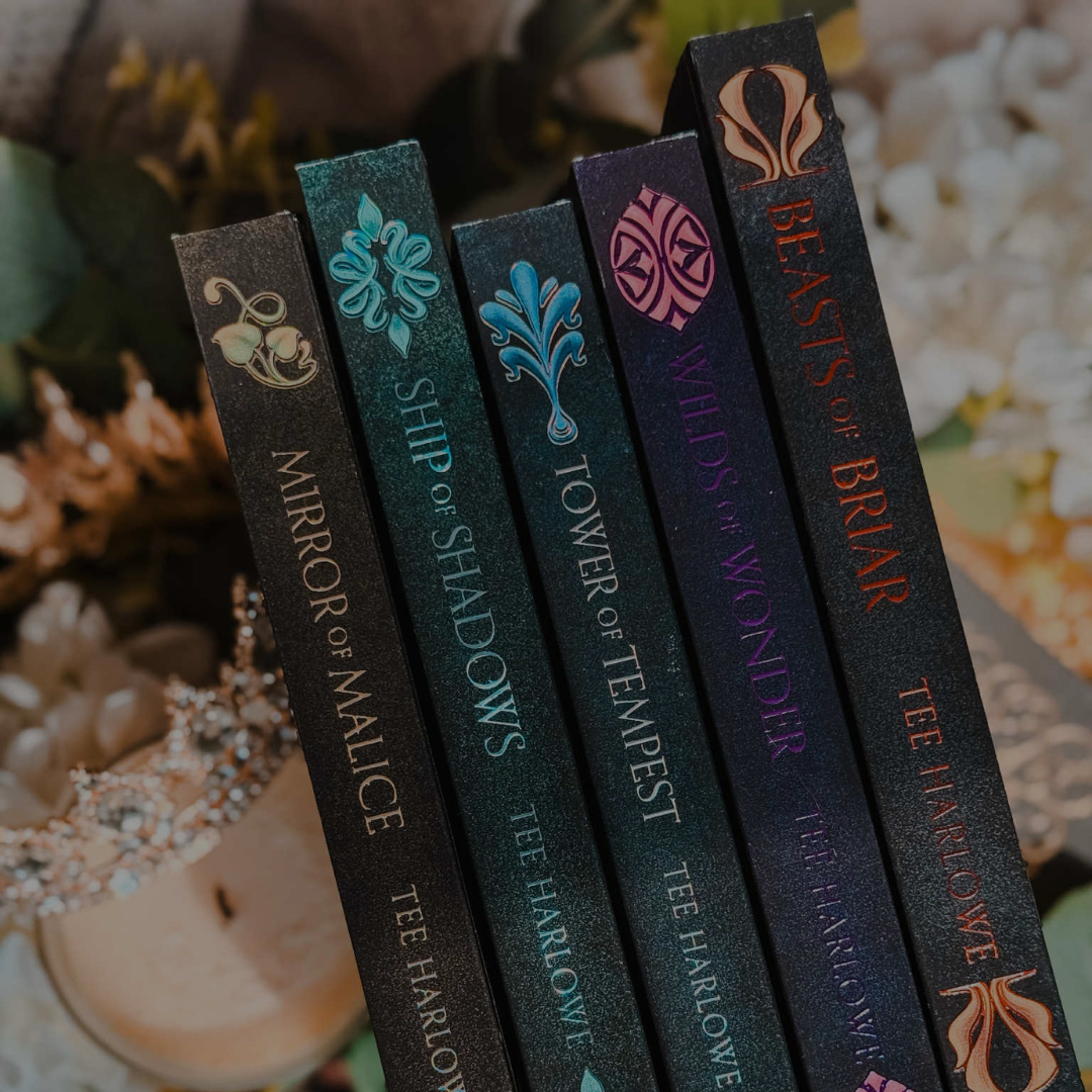 Collection of book covers with titles and author name on a textured surface