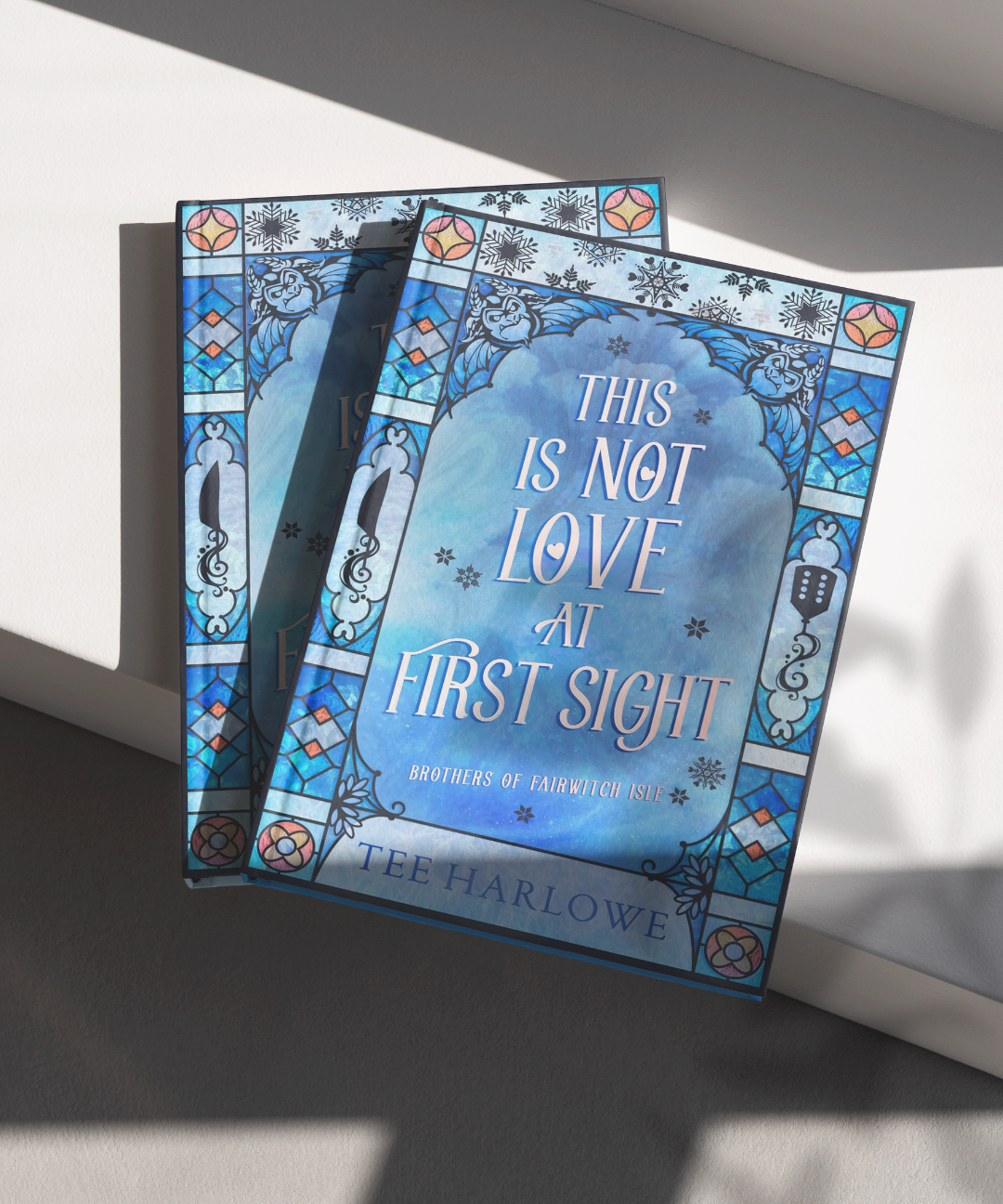 Book titled 'This is Not Love at First Sight' by Tee Harlowe with decorative cover on a light background