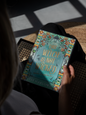 Book titled 'This Witch is Not Wicked' held by a person with a dark background