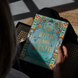 Book titled 'This Witch is Not Wicked' held by a person with a dark background